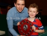 Aaron McHenry from Central Restaurant Ballycastle presenting Brid Og team captain Conor Graham with the Central Restaurant U8 Indoor Hurling Division 3 Shield